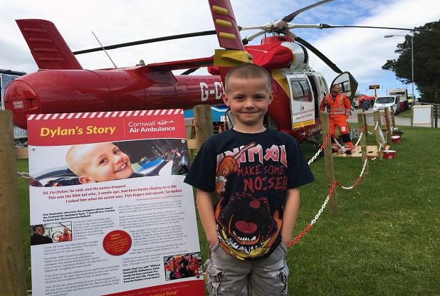 Dylan Kneebone in front of the current Cornwall Air Ambulance